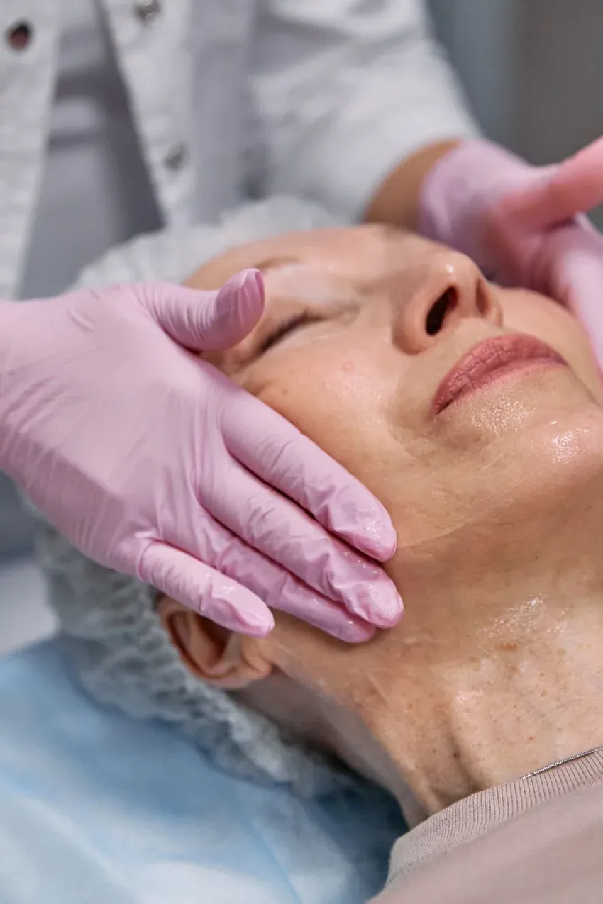 Older woman receiving a relaxing anti-ageing facial