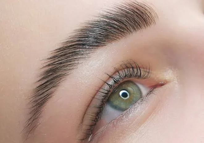 Applying false eyelashes with tweezers